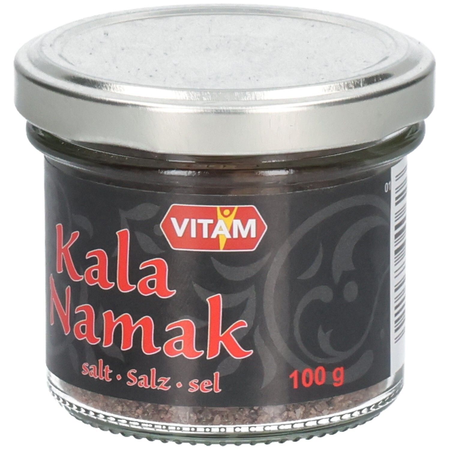 Pot en verre avec étiquette noire. Inscription rouge "Kala Namak". Marque VITAM. Couvercle argenté. Sel visible.