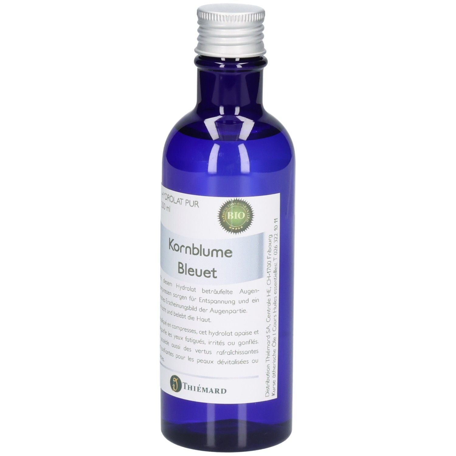 Blaue Glasflasche mit silbernem Verschluss, gefüllt mit Kornblumenhydrolat. BIO-Siegel und "Kornblume Bleuet" Aufschrift.