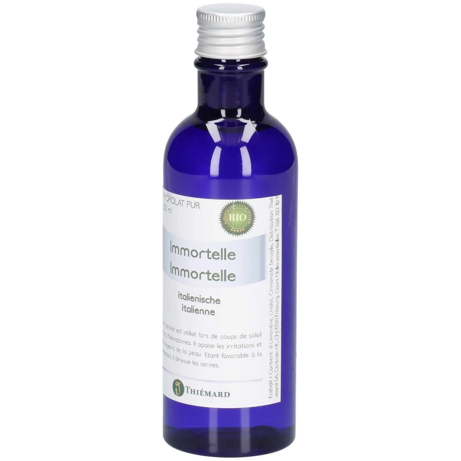 Blaue Glasflasche mit silbernem Verschluss, Etikett mit "Immortelle" und "Italienische". BIO-Siegel sichtbar.