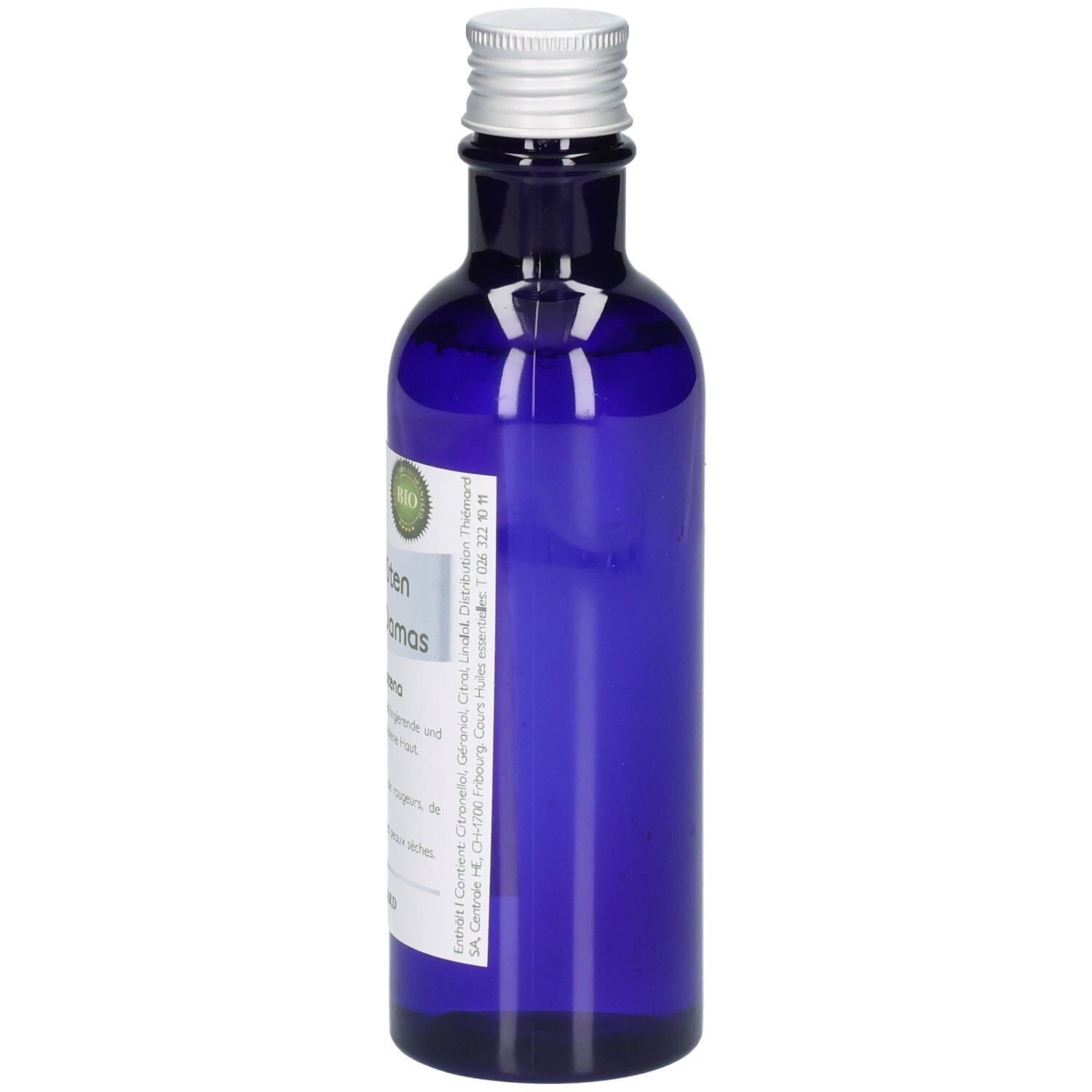 Blaue Glasflasche mit silbernem Verschluss, Etikett mit Bio-Siegel und Text.