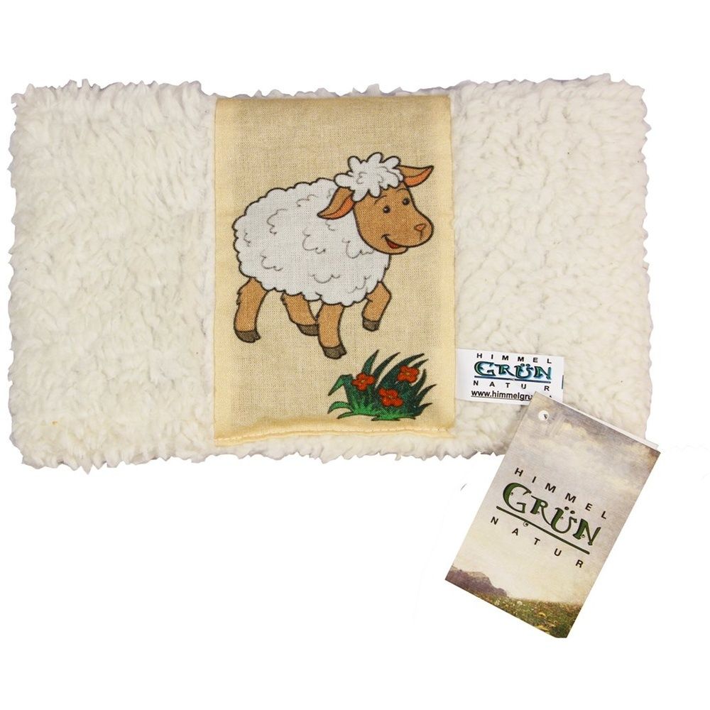 Coussin rectangulaire avec motif mouton. Fourrure crème, centre beige avec dessin de mouton. Étiquette avec logo.