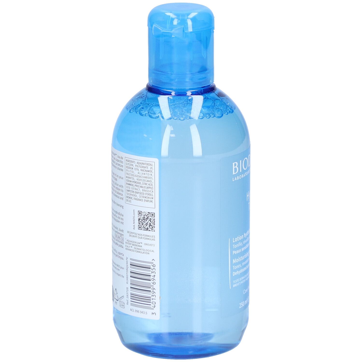 Dos du flacon bleu. Texte multilingue. Code QR et code-barres. Liquide transparent visible.