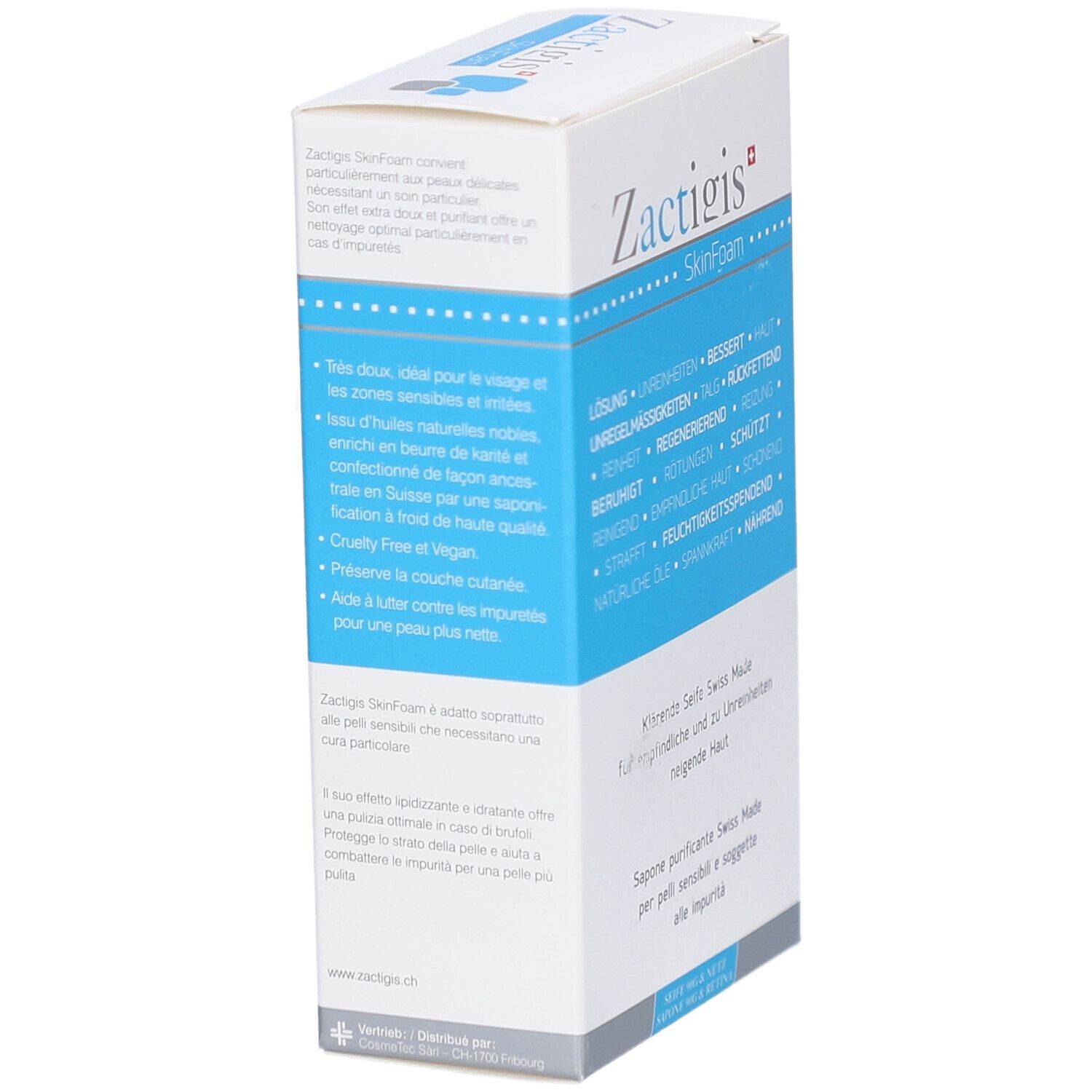 Boîte blanche et bleue. Inscription: Zactigis SkinFoam. Texte en allemand, français et italien. Vue oblique du produit.