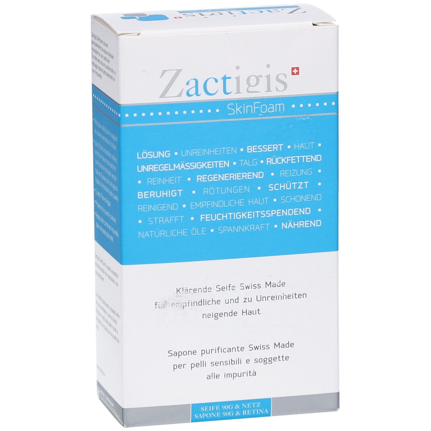 Boîte blanche et bleue. Inscription: Zactigis SkinFoam. Texte en allemand, français et italien. Vue oblique du produit.