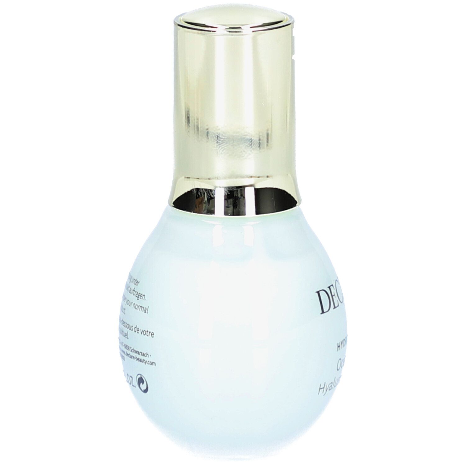 Flacon bleu clair avec bouchon doré. Texte au dos en plusieurs langues.