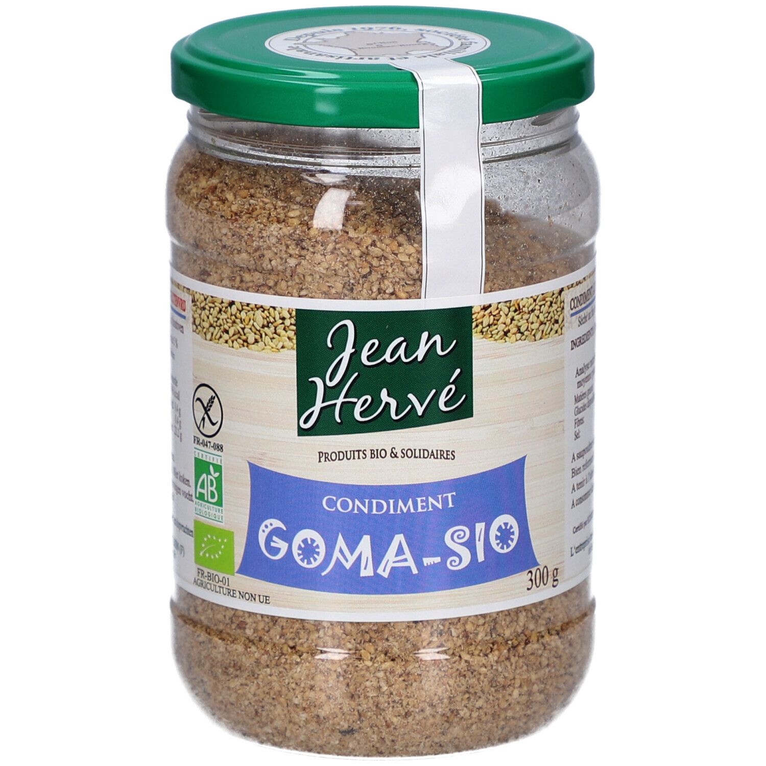 Glas mit Gomasio. Grüner Deckel, weißes Etikett mit Logo und Text. Bio-Zertifizierung.