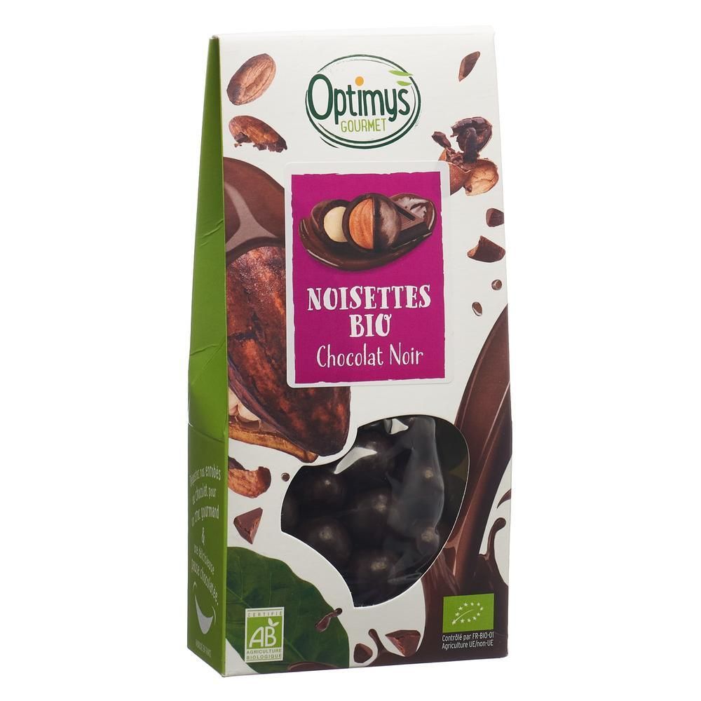 Verpackung mit OPTIMYS Gourmet Haselnusskerne dunkle Schokolade Bio. Sichtfenster zeigt Schokoladenkugeln. Logo und Text auf der Verpackung.