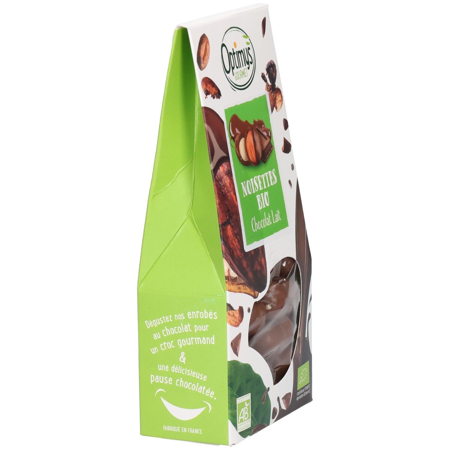 Schrägansicht der Verpackung. Grüne Seite mit Text und Logo. Sichtfenster mit Schokoladenkugeln. Marke: Optimys Gourmet.