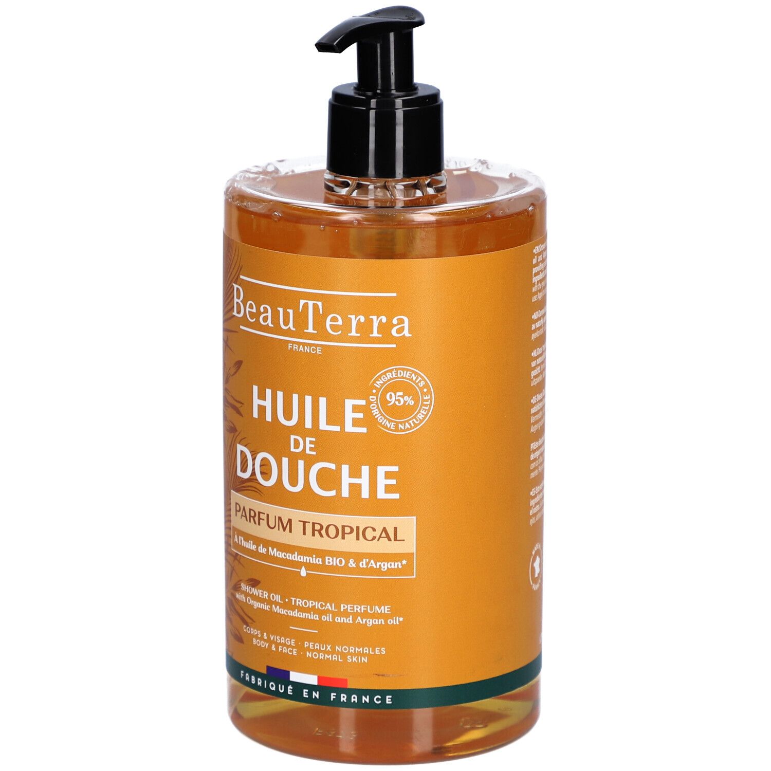 Flacon transparent avec pompe noire. Inscription : "Huile de Douche Parfum Tropical".
