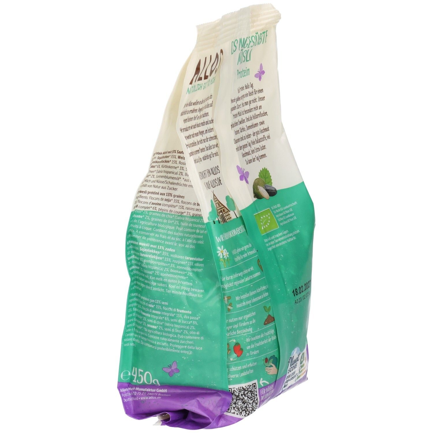 Seitenansicht der Verpackung von ALLOS Bio Protein Müsli ungesüßt. Grün-weiße Tüte mit Produktinformationen und Logo. Enthält Bio-Siegel und Mindesthaltbarkeitsdatum.