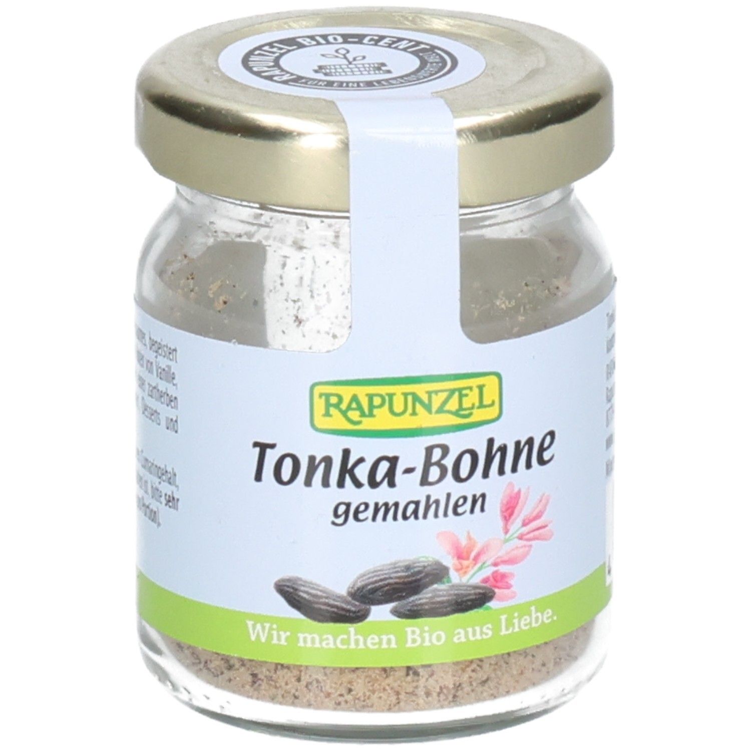 Pot en verre de fèves tonka moulues. Étiquette avec nom du produit, marque RAPUNZEL, illustrations et texte. Label bio.
