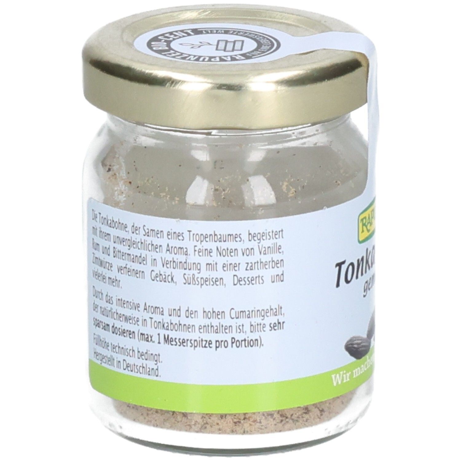 Pot de fèves tonka moulues. Dos avec texte sur le produit. Couvercle doré. Étiquette blanche.