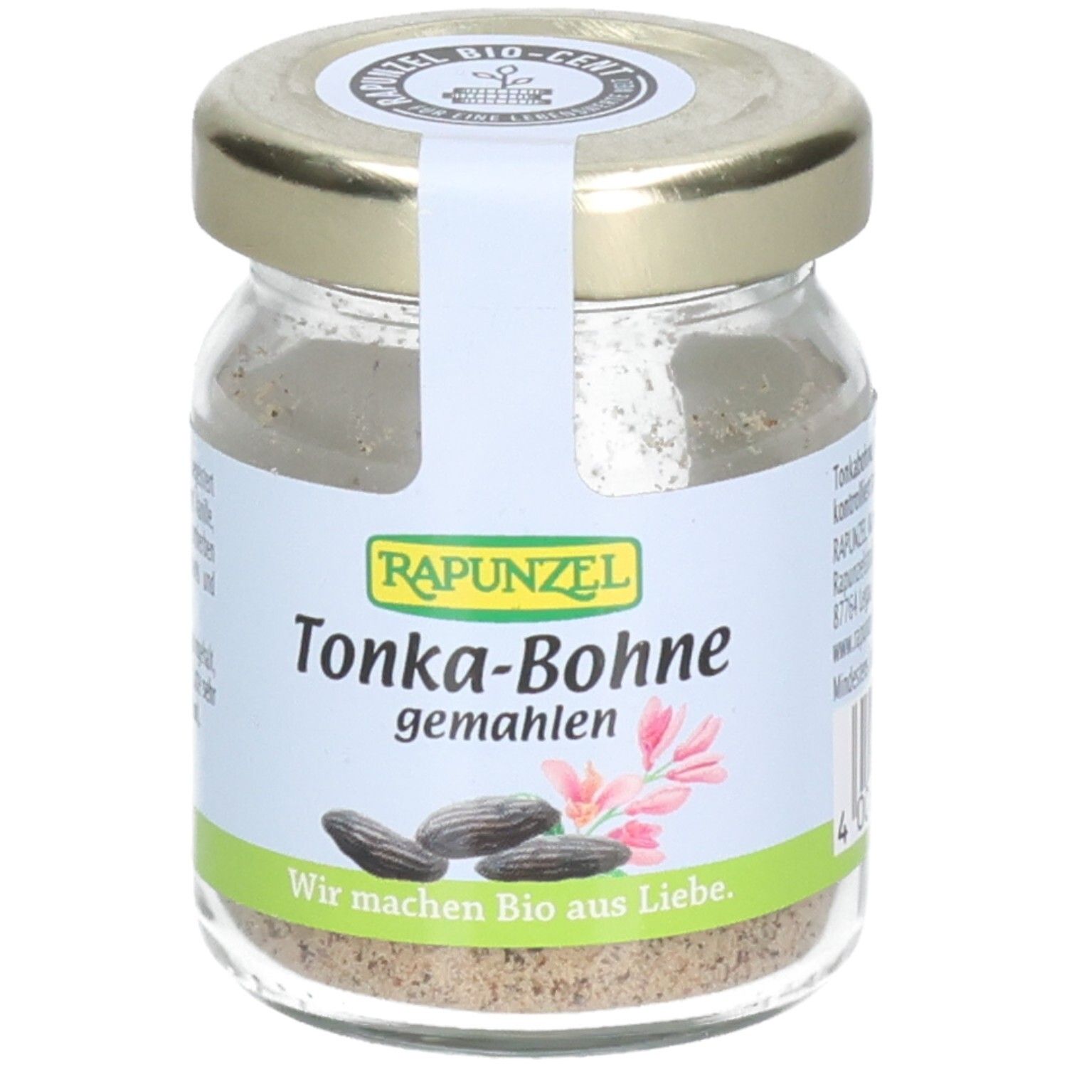 Pot de fèves tonka moulues. Étiquette avec nom du produit, marque RAPUNZEL, illustrations et texte. Couvercle doré.