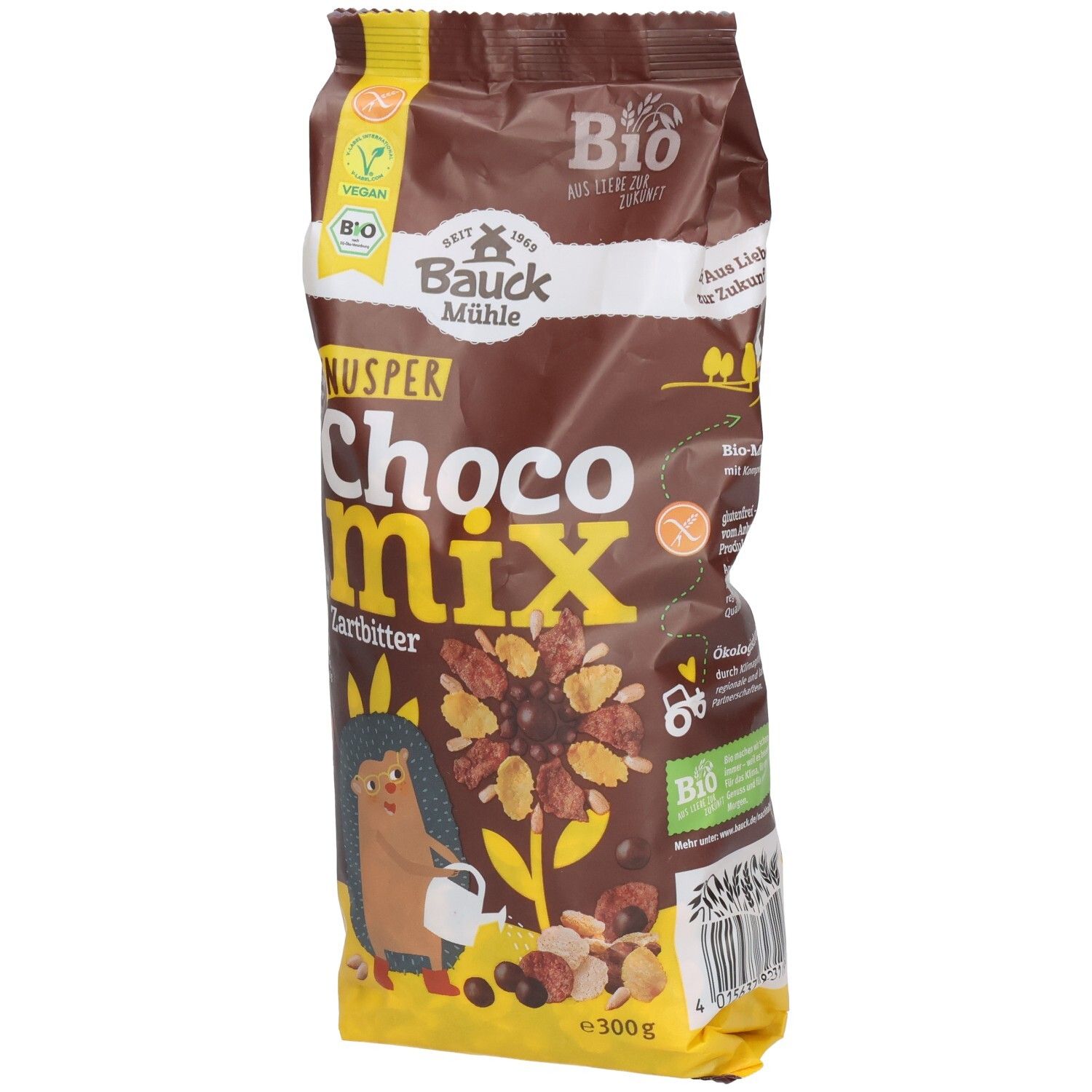 Sachet marron "KNUSPER Choco Mix Zartbitter". Logos vegan et bio. Illustration d'un hérisson et de céréales.