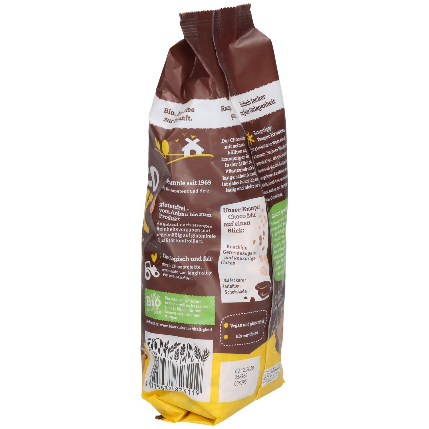 Sachet marron, vue latérale. Texte "KNUSPER Choco Mix glutenfrei". Logo bio. Texte et informations nutritionnelles.