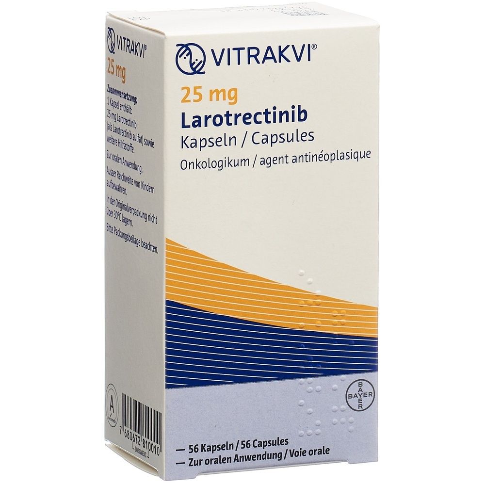Boîte en carton avec informations produit. Inscription: VITRAKVI Kaps 25 mg. Couleurs: blanc, bleu, jaune. Logo du fabricant en haut à gauche.