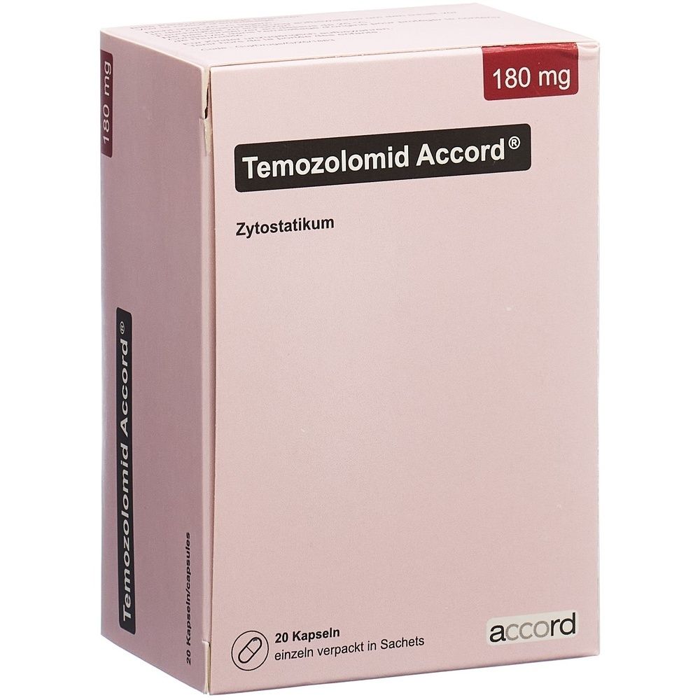 Boîte en carton rectangulaire rose clair. Texte noir sur le devant. Bande rouge en haut. Nom du produit illisible.