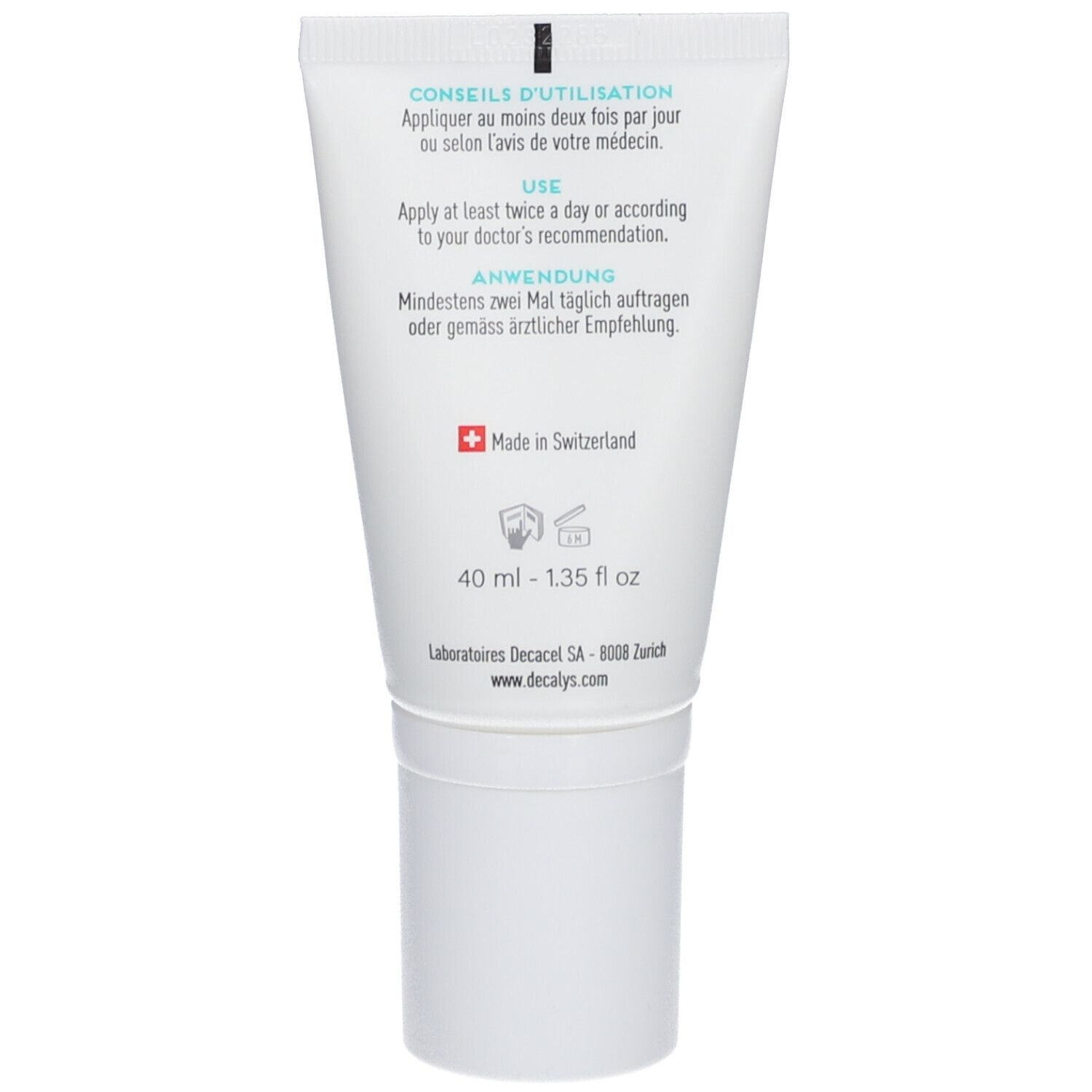 Dos du tube avec informations d'utilisation et fabricant. Contient du texte en français, allemand et anglais. Fabriqué en Suisse.