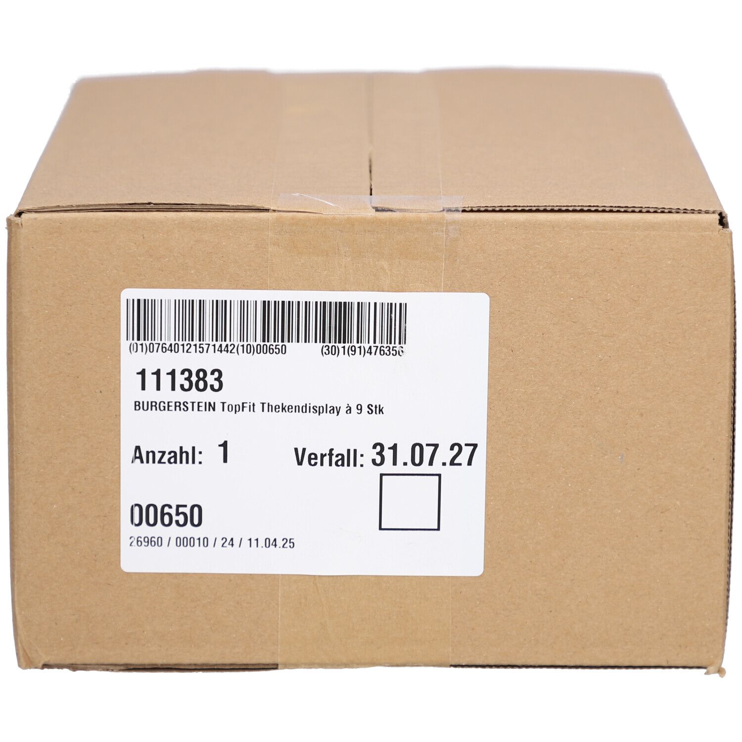 Braune Schachtel mit weißem Etikett. Text und Barcode. Verfallsdatum: 31.07.27.