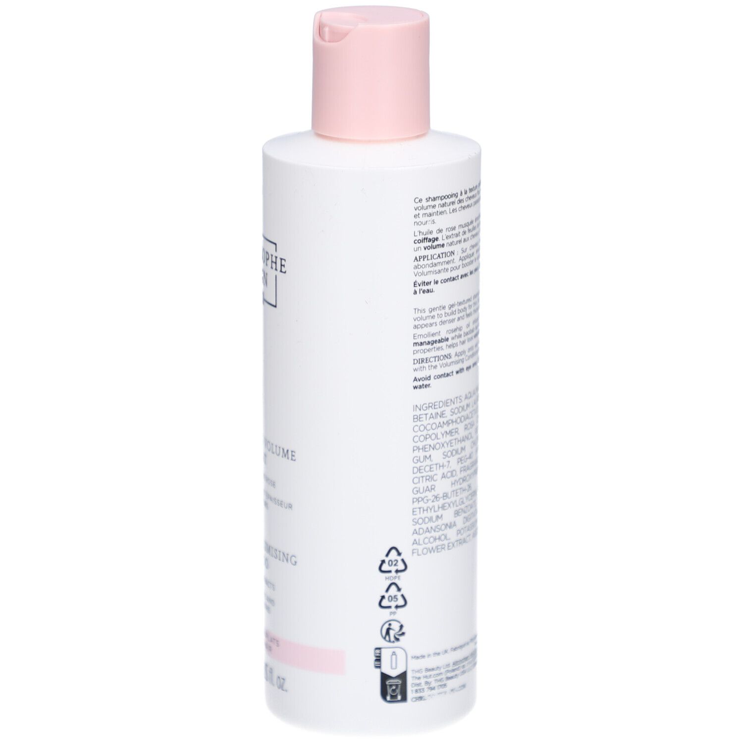 Dos du flacon de shampooing. Texte et symboles visibles. Flacon blanc avec détails roses.