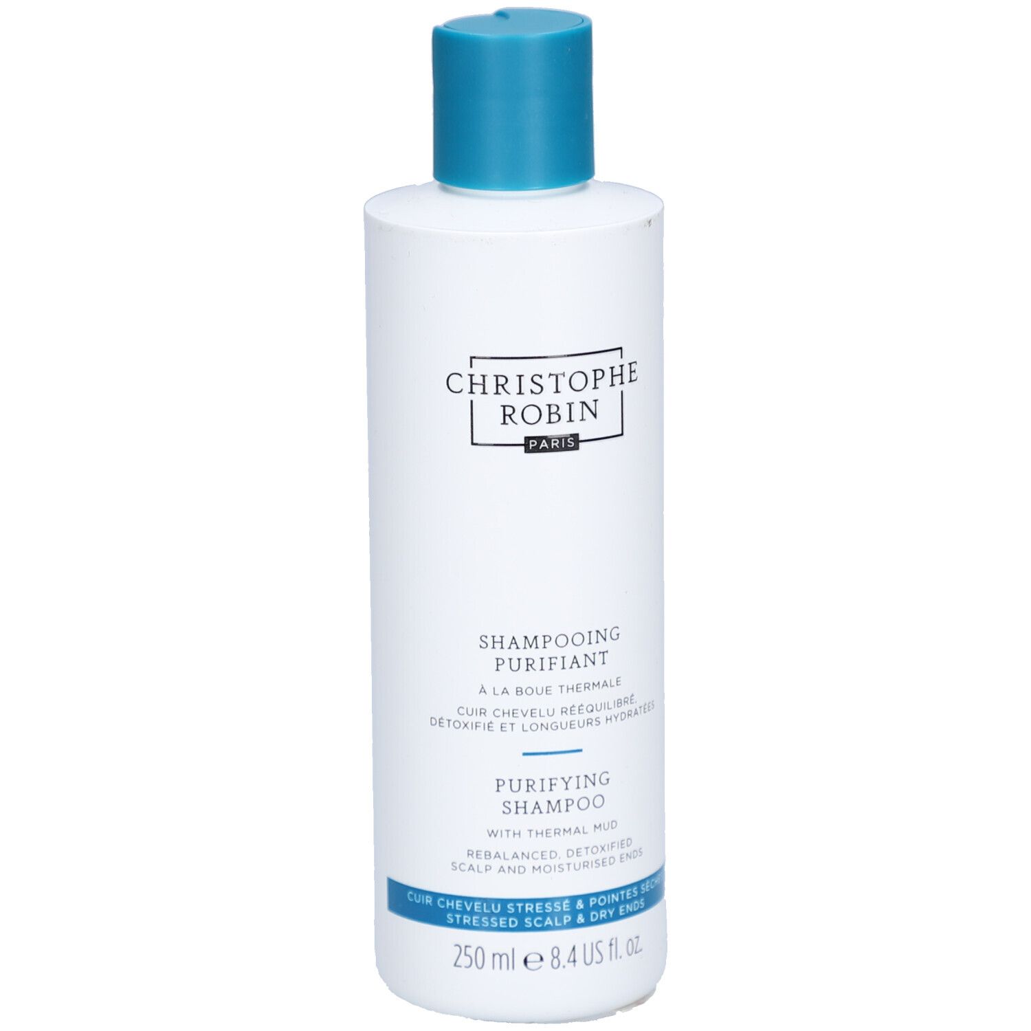 Weiße Flasche mit blauem Deckel. Aufschrift: CHRISTOPHE ROBIN, SHAMPOOING PURIFIANT, PURIFYING SHAMPOO. 250 ml.