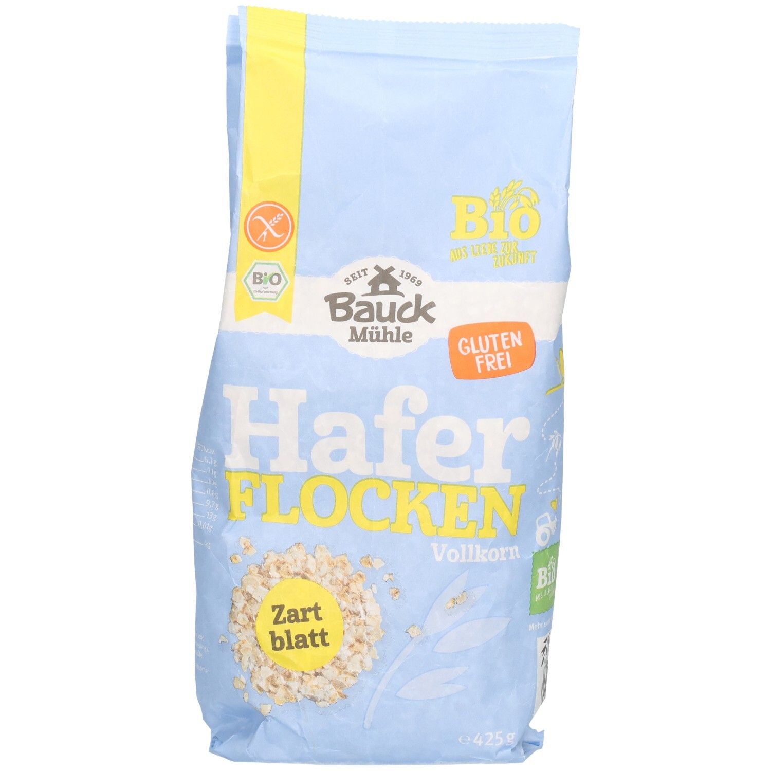Sachet bleu clair de flocons d'avoine. Inscription : Bauck Mühle, flocons d'avoine complets tendres sans gluten. Label bio et logo sans gluten.