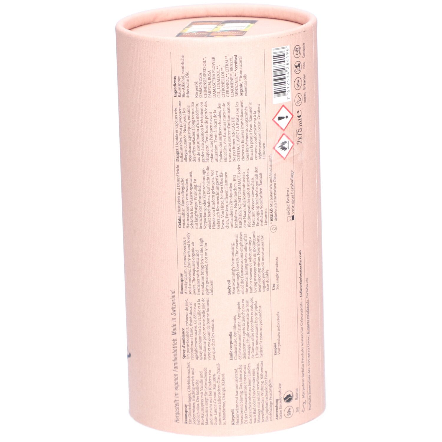 Zylindrische, rosa Geschenkverpackung. Rückseite mit Text in mehreren Sprachen. Enthält 2x75 ml. Mit Bio-Rose & Vanille.