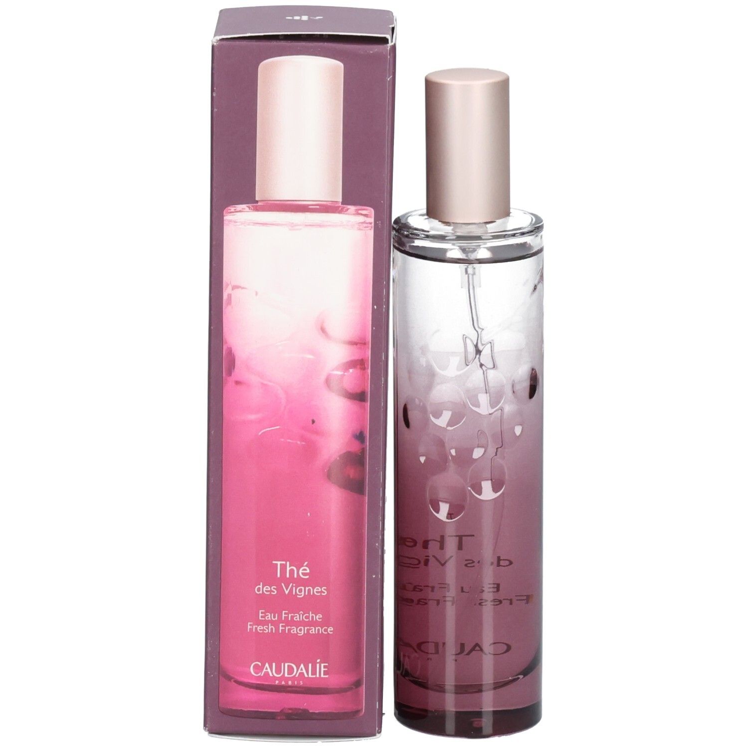 Flacon et emballage. Flacon cylindrique dégradé rose. Bouchon rose. Inscription: Thé des Vignes, CAUDALIE.