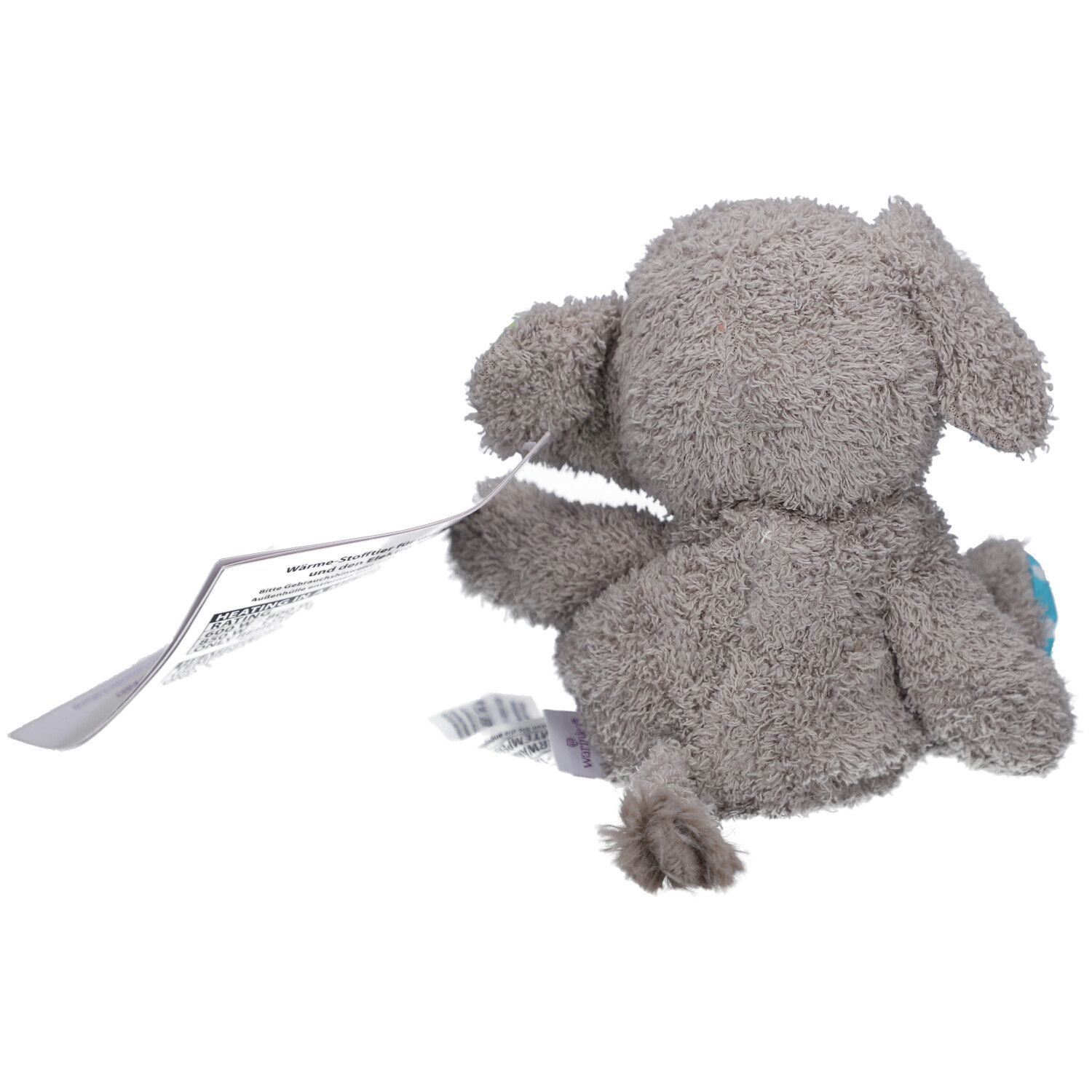 Vue arrière d'un éléphant en peluche gris avec étiquette. Petite pointe de queue visible.