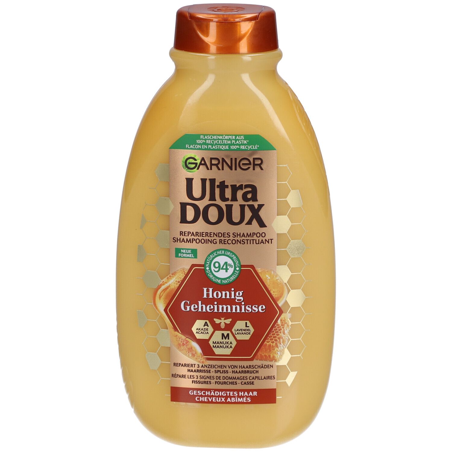 Flacon de shampooing Garnier Ultra Doux. Jaune avec bouchon marron. Étiquette avec nom, illustration de miel et texte.