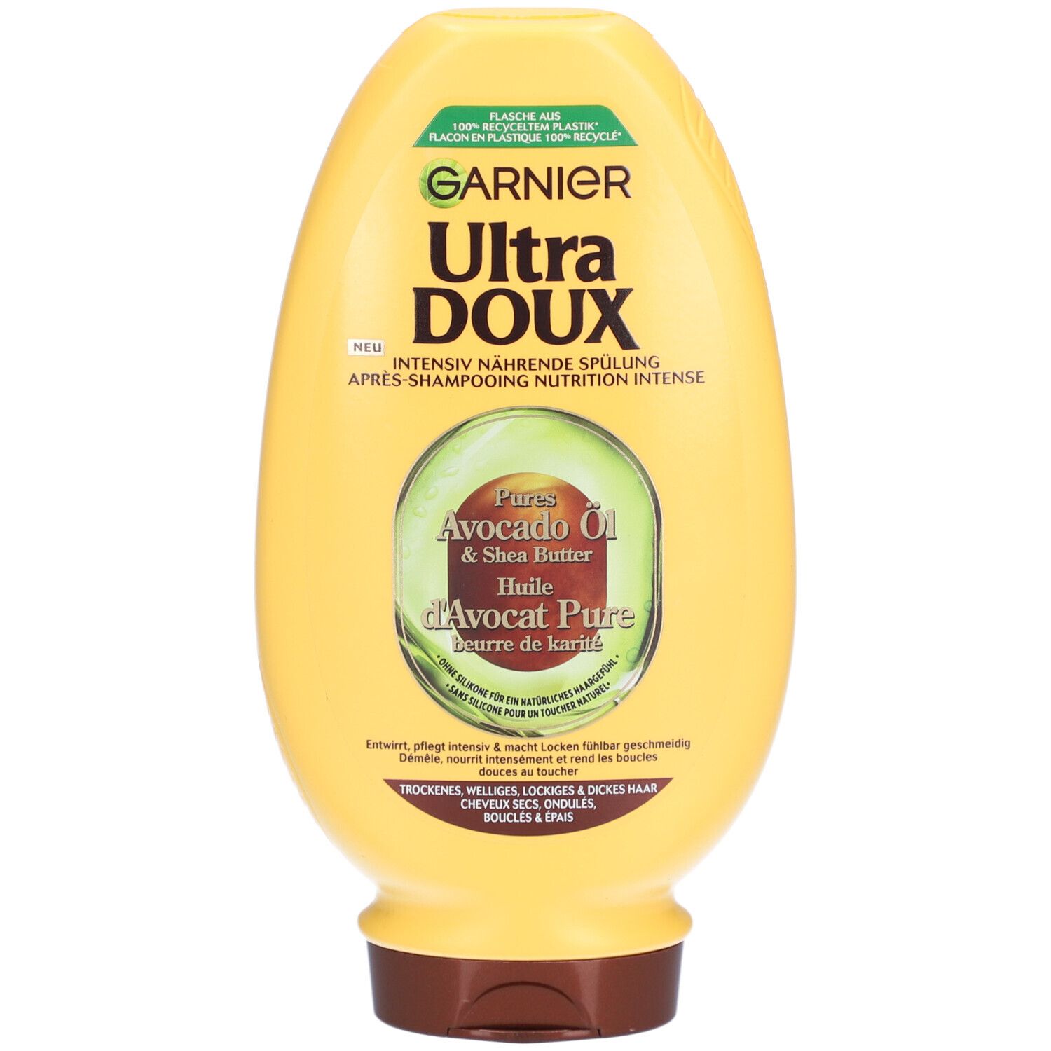 Flacon jaune Garnier Ultra Doux. Huile d'avocat & beurre de karité. Inscription: Après-shampooing nutrition intense. Pour cheveux secs, bouclés.