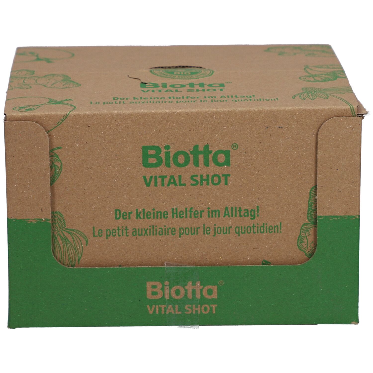 Kartonverpackung von Biotta Vital Shot. Grün-braune Farbgebung. Aufschrift: Biotta Vital Shot, Der kleine Helfer im Alltag! Le petit auxiliaire pour le jour quotidien!