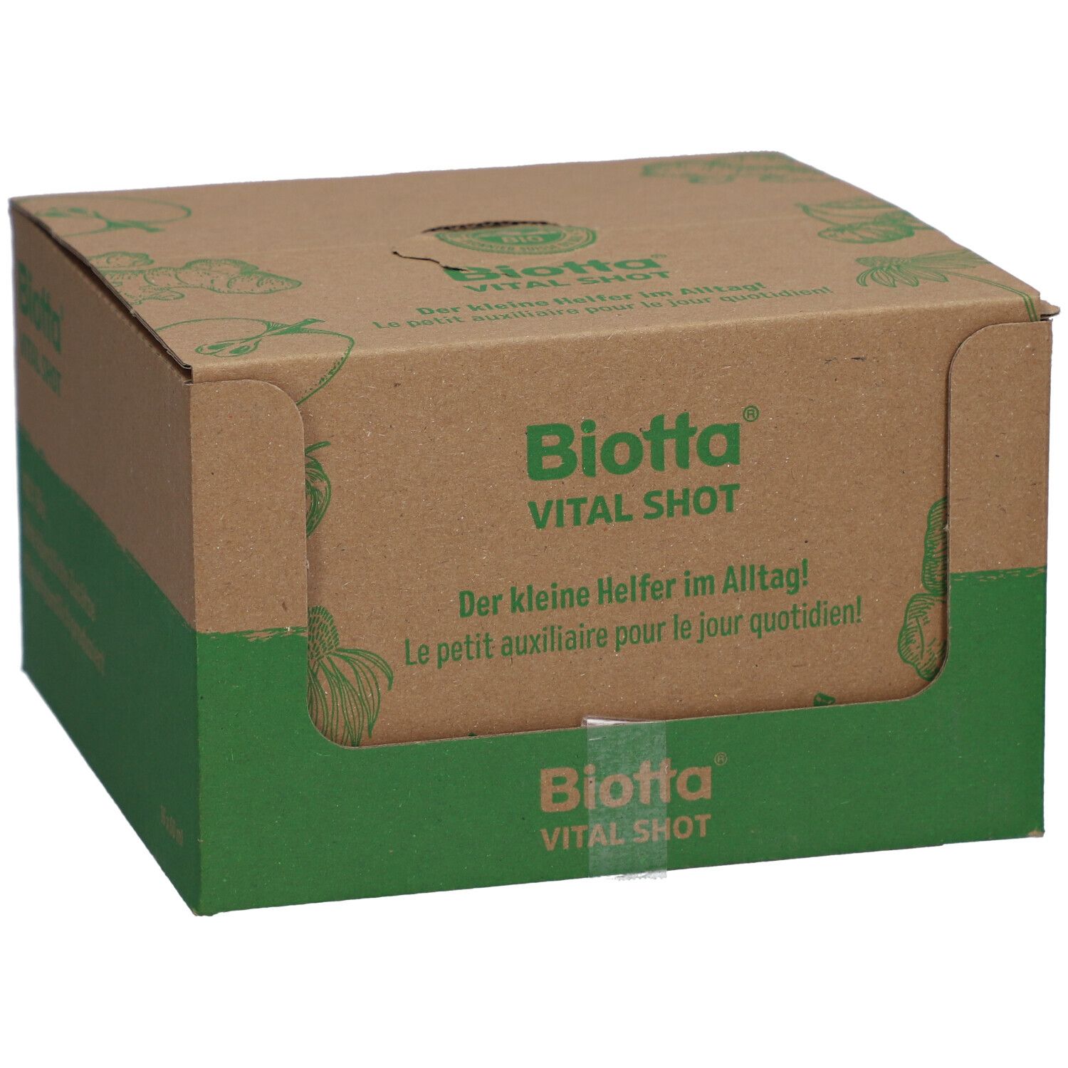 Kartonverpackung von Biotta Vital Shot. Grün-braune Farbgebung. Aufschrift: Biotta Vital Shot, Der kleine Helfer im Alltag! Le petit auxiliaire pour le jour quotidien!
