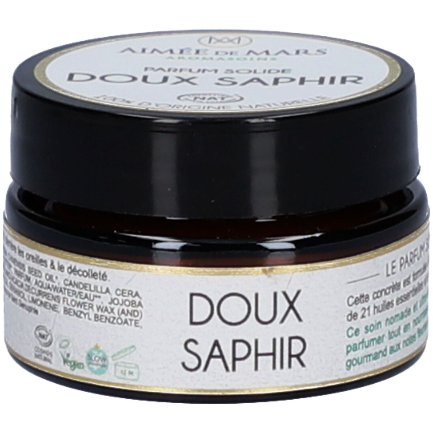 Petit pot rond avec couvercle noir. Inscription: Doux Saphir. Label Vegan. Ingrédients et certifications sur l'étiquette.