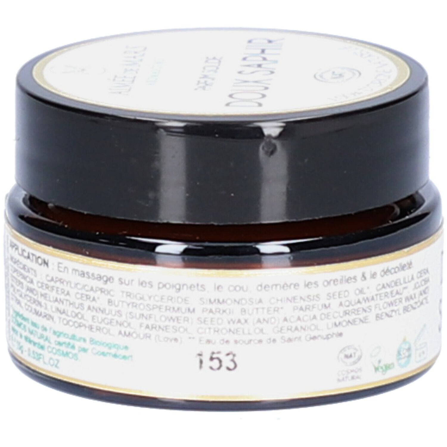 Petit pot rond avec couvercle noir. Inscription: Doux Saphir. Ingrédients et instructions d'utilisation sur l'étiquette. Label Vegan.