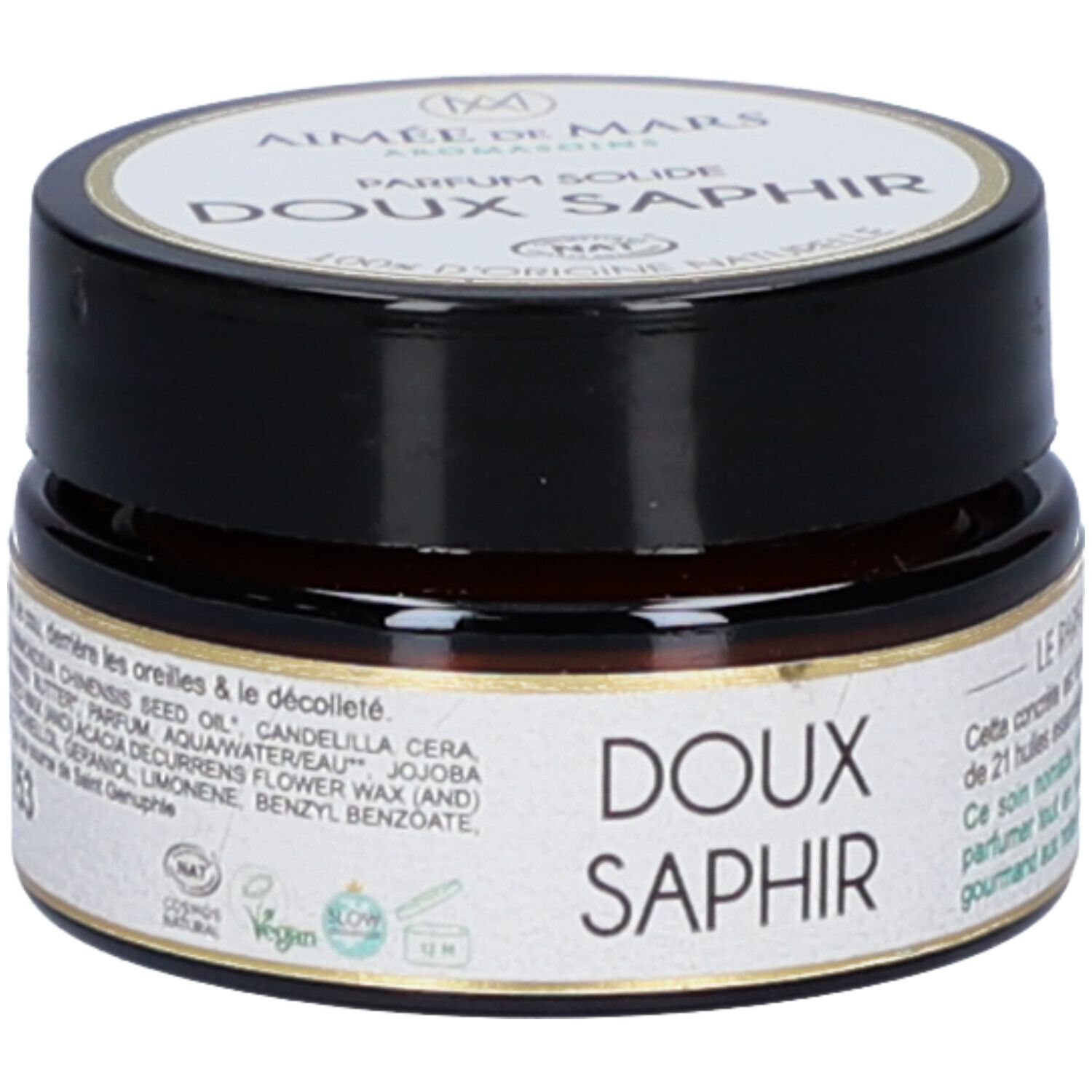 Petit pot rond avec couvercle noir. Inscription: Doux Saphir. Ingrédients et certifications sur l'étiquette. Label Vegan.