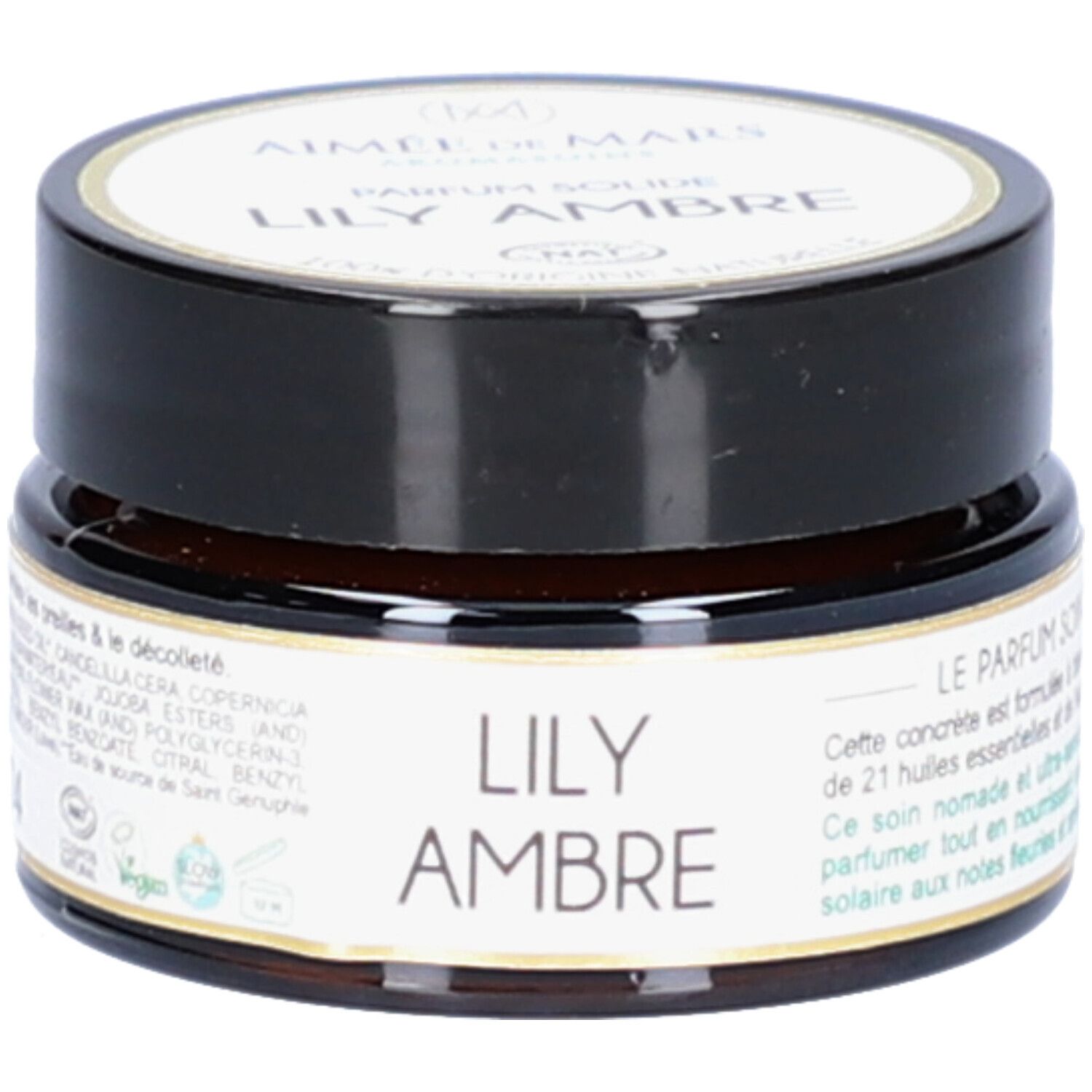 Pot en verre brun avec couvercle noir. Étiquette avec nom du produit et marque. Inscription : Lily Ambre Parfum Solide.
