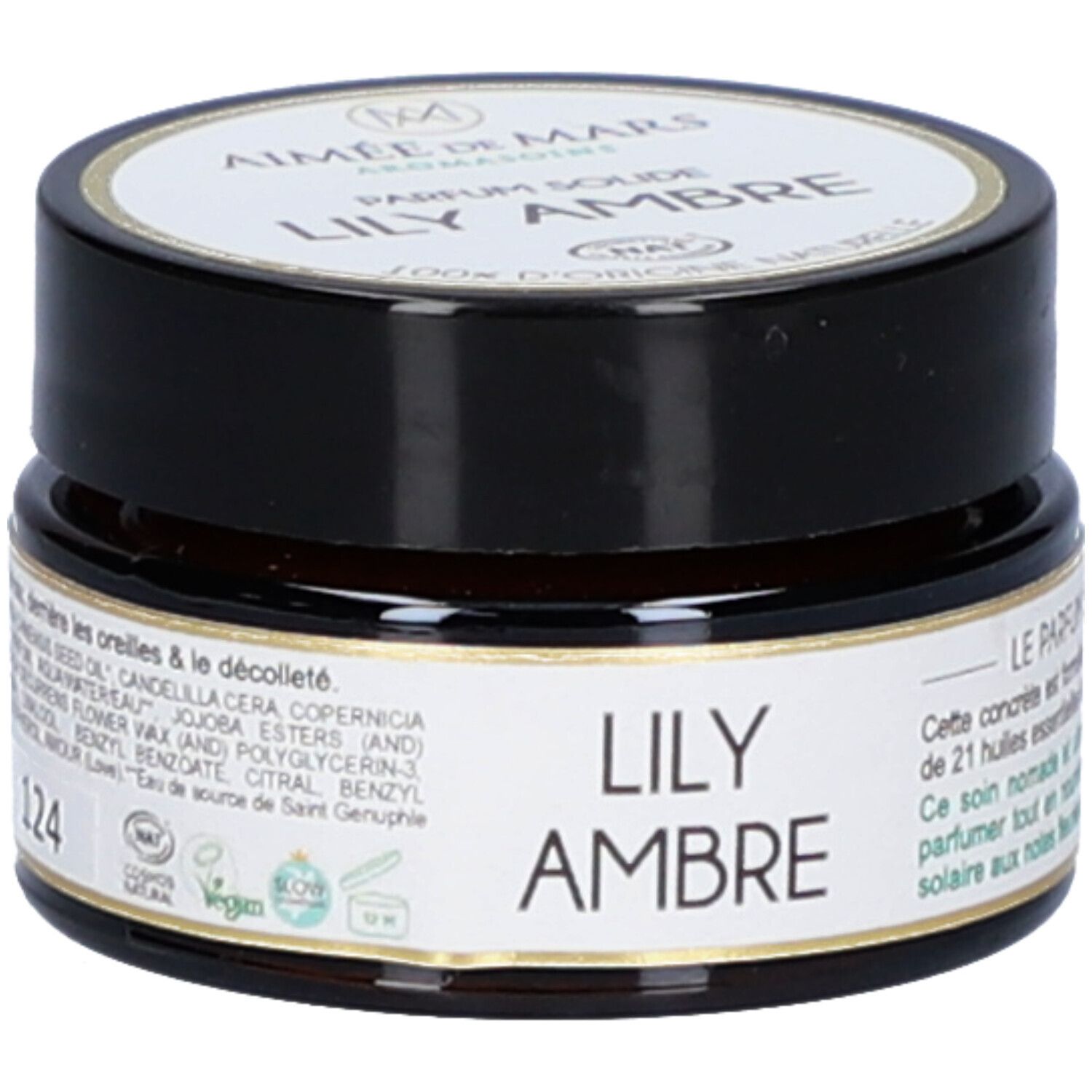 Pot en verre brun avec couvercle noir. Étiquette avec nom du produit et marque. Inscription : Lily Ambre Parfum Solide. 124.