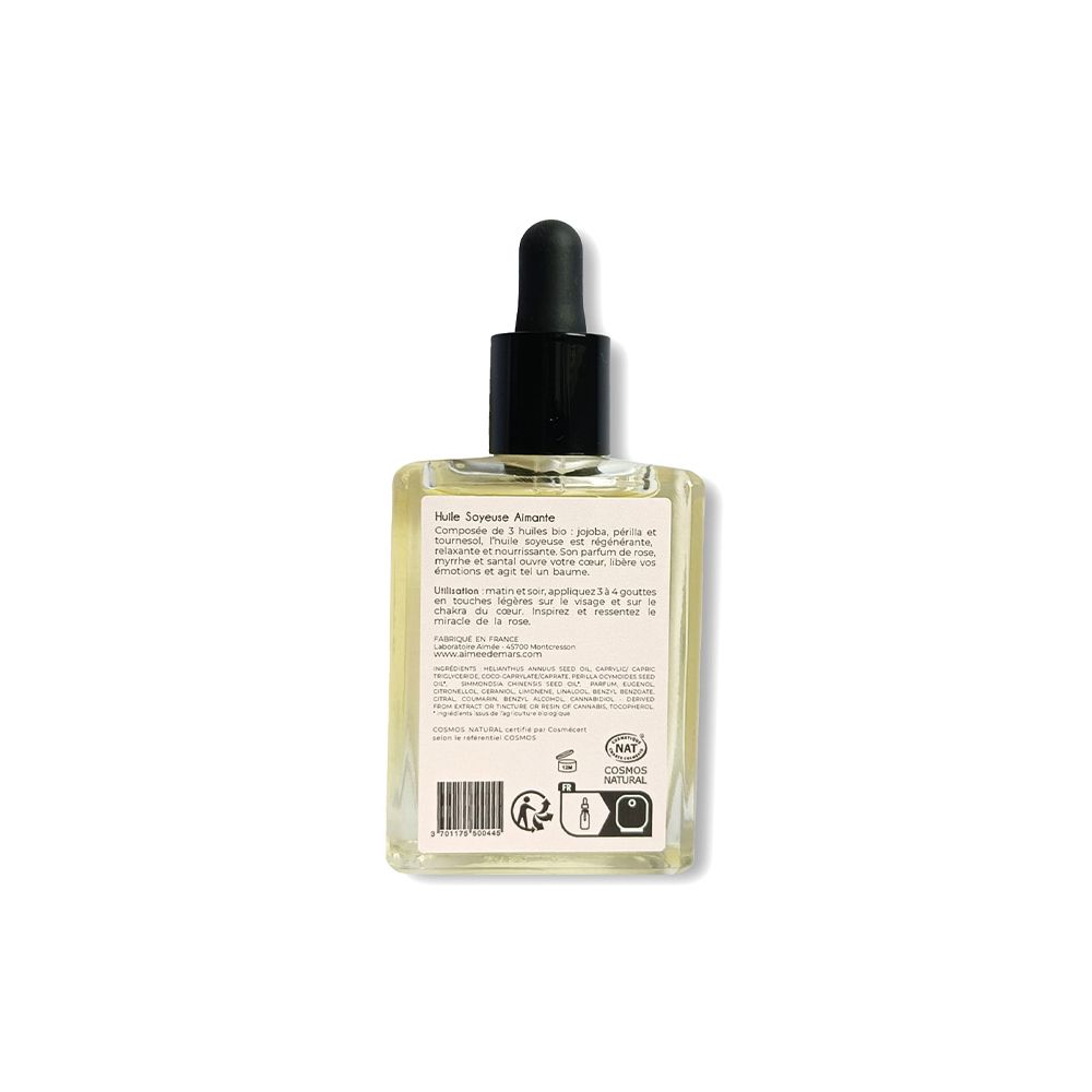 Rückseite der Glasflasche. Etikett mit Text und Logos. Transparente Flüssigkeit sichtbar. NAT-Zertifizierung.