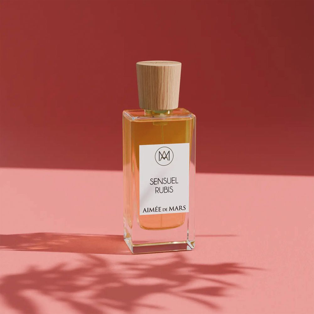 Flacon de parfum avec bouchon en bois. L'étiquette indique "Sensuel Rubis" et "Aimée de Mars".