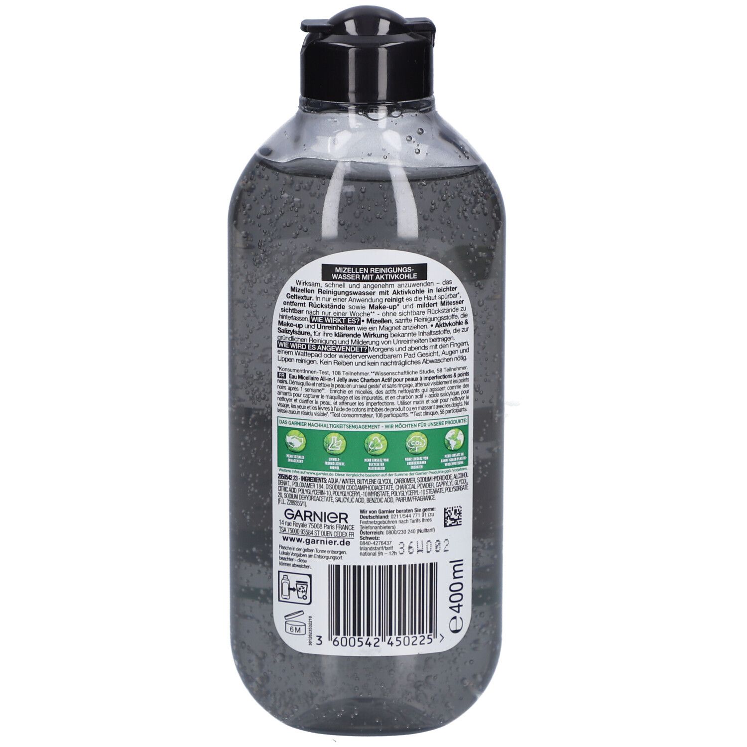 Dos d'un flacon transparent contenant un liquide noir. Texte et logos Garnier et labels environnementaux.