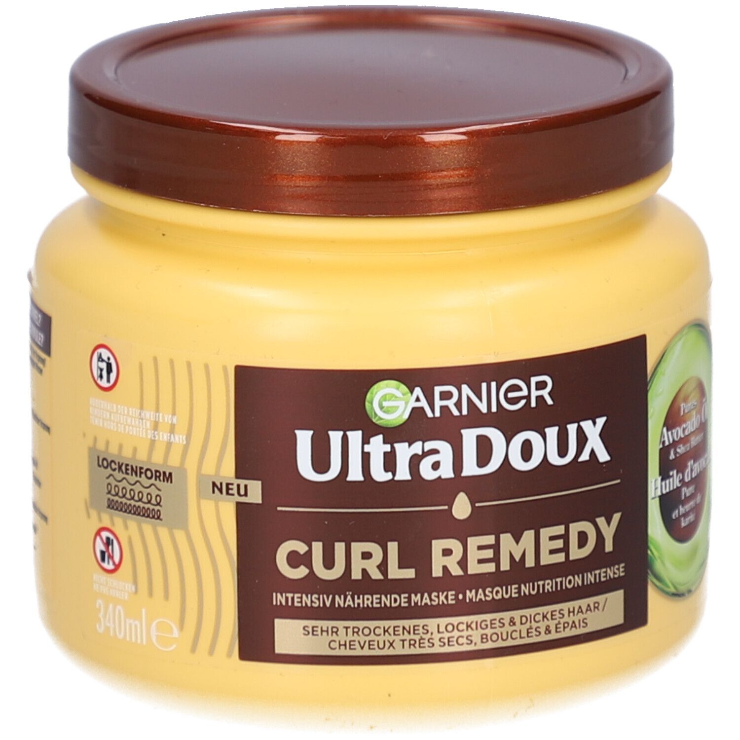 Pot jaune avec couvercle marron. Inscription: GARNIER Ultra Doux CURL REMEDY. Huile d'avocat et beurre de karité. 340ml.