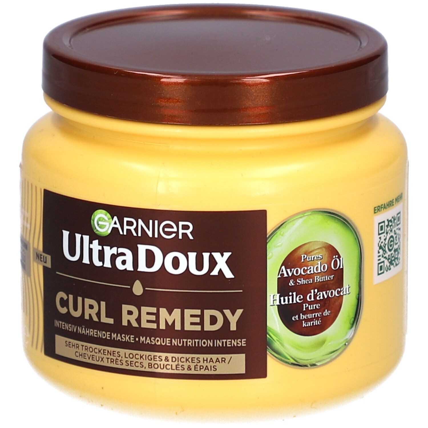 Pot jaune avec couvercle marron. Inscription: GARNIER Ultra Doux CURL REMEDY. Huile d'avocat et beurre de karité. Pour cheveux bouclés.