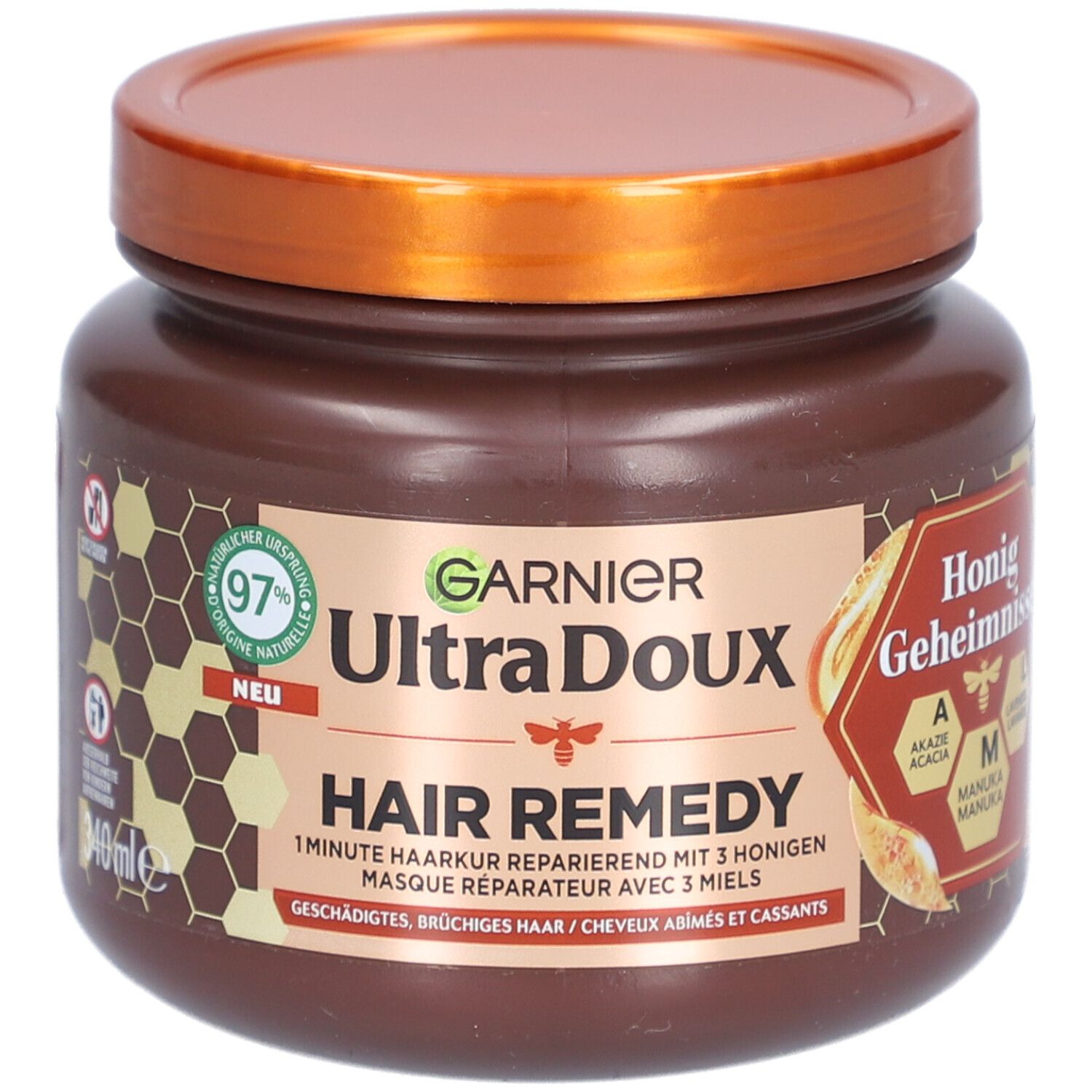 Pot marron avec couvercle. Inscription: GARNIER Ultra Doux Hair Remedy. Secrets de miel. 97% d'origine naturelle.