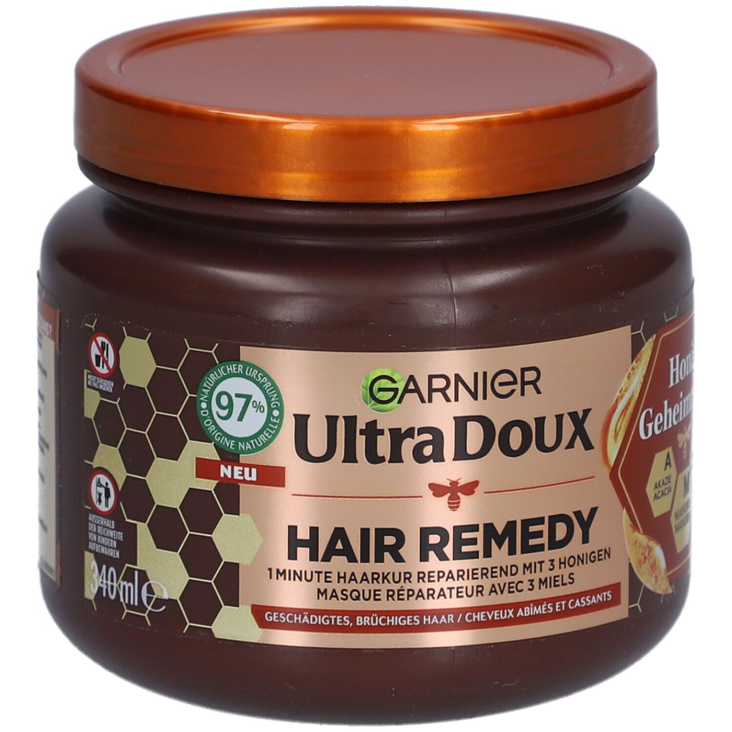 Pot marron avec couvercle. Inscription: GARNIER Ultra Doux Hair Remedy. Secrets de miel. 97% d'origine naturelle.