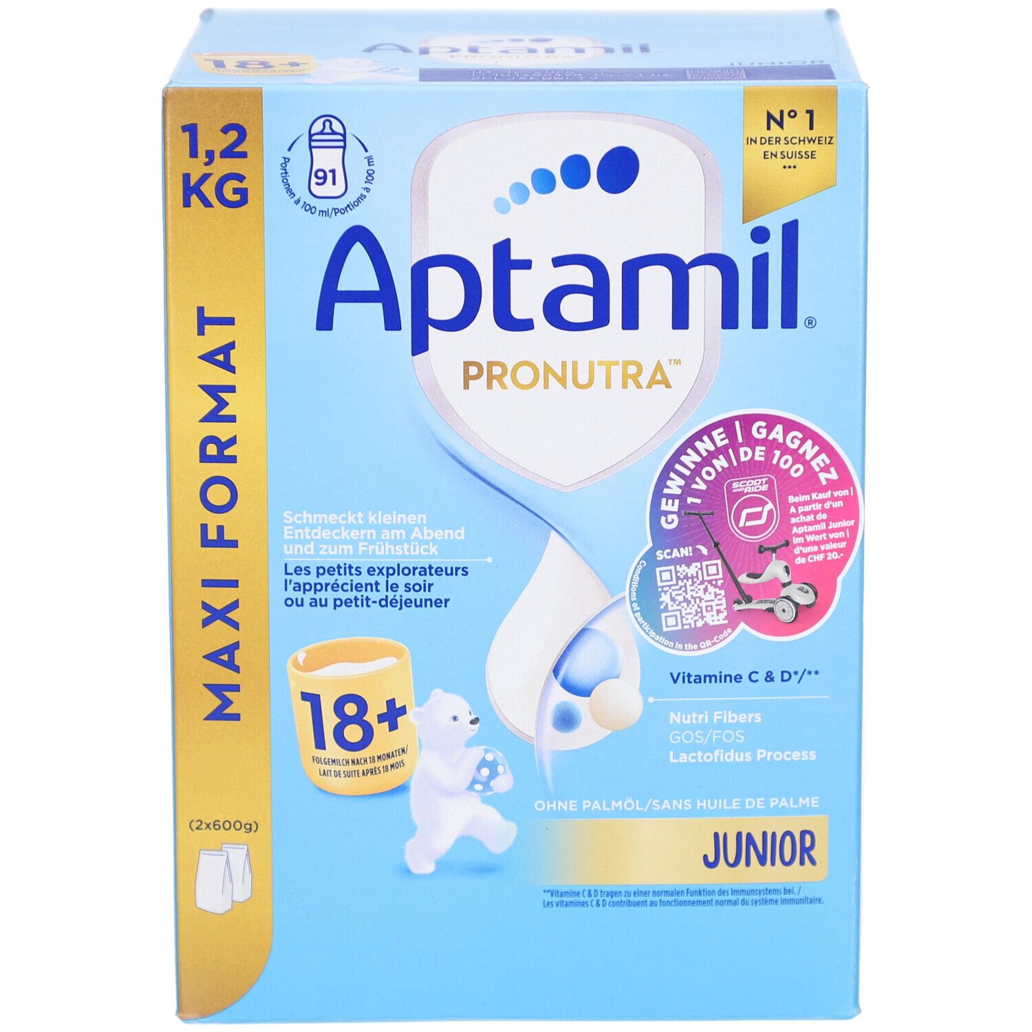 Boîte en carton, bleu et blanc. Contient Aptamil Pronutra Juniormilch 18+. Format Maxi 1,2 kg. Avec illustrations.