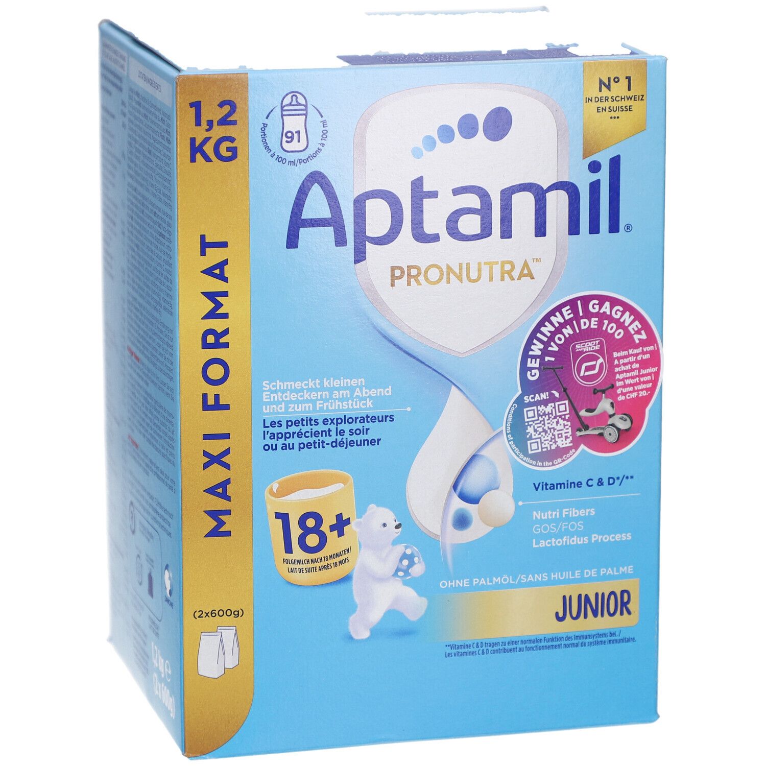 Boîte en carton, bleu et blanc. Contient Aptamil Pronutra Juniormilch 18+. Format Maxi 1,2 kg. Avec illustrations.