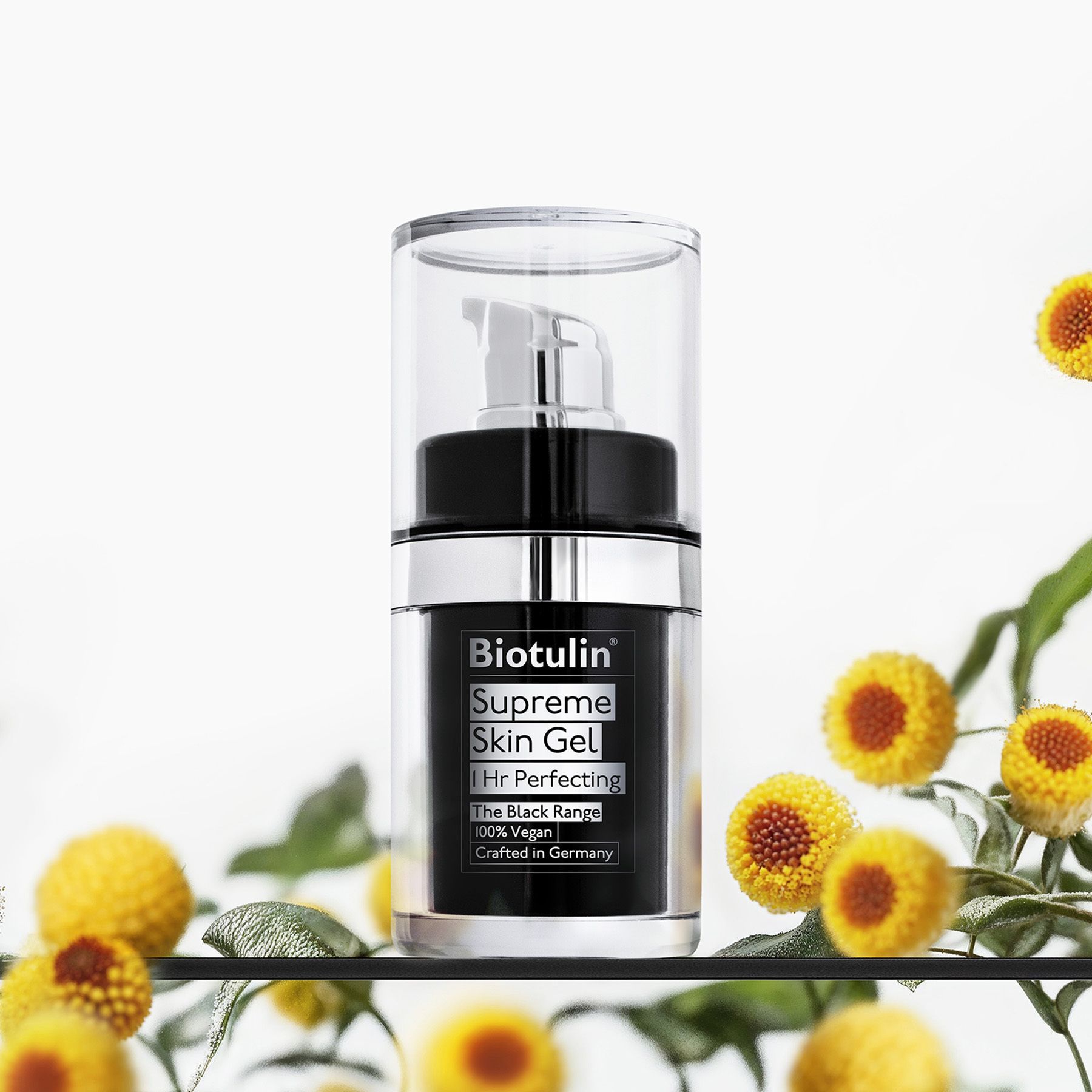 Biotulin Supreme Skin Gel en flacon noir avec distributeur, entouré de fleurs.