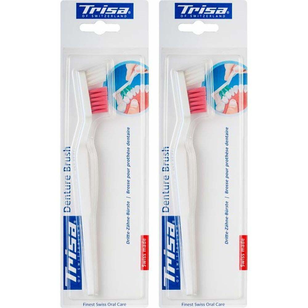 Zwei Trisa Prothesenbürsten in Blisterverpackung. Weiße Griffe, rosa Borsten. Aufschrift: Denture Brush, Trisa.