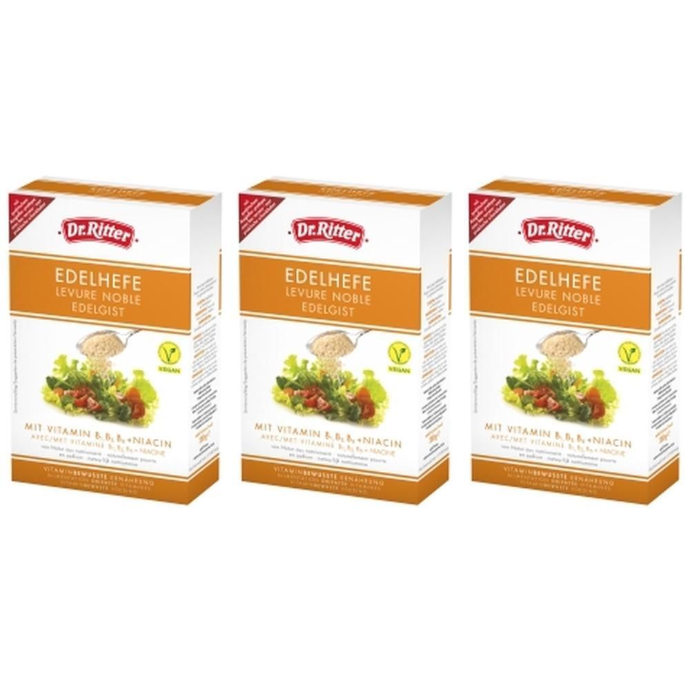 Trois boîtes de flocons de levure DR. Ritter Edelhefe. Emballage blanc et orange avec nom, image et label vegan.